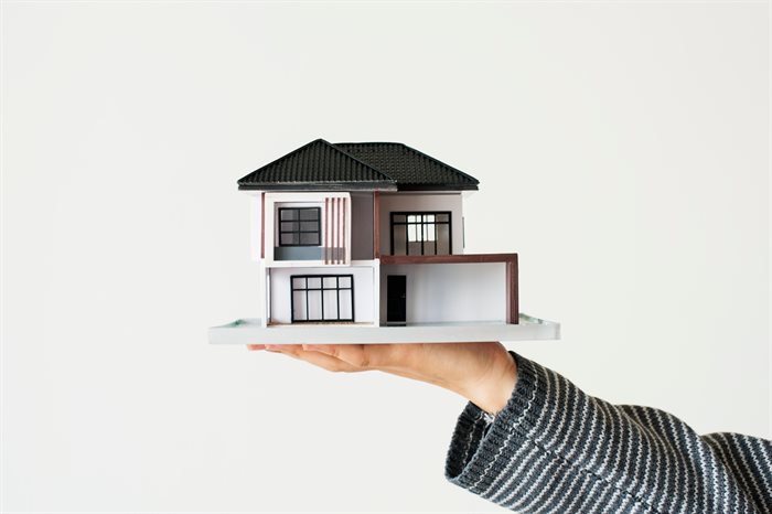 hand-presenting-model-house-for-home-loan-campaign.jpg