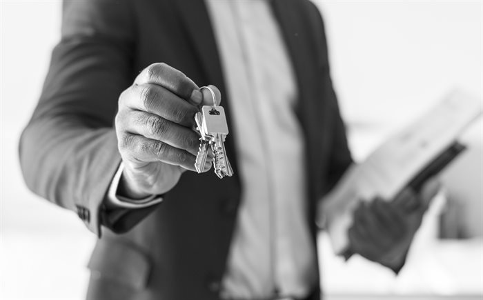 real-estate-agent-handing-the-house-key.jpg
